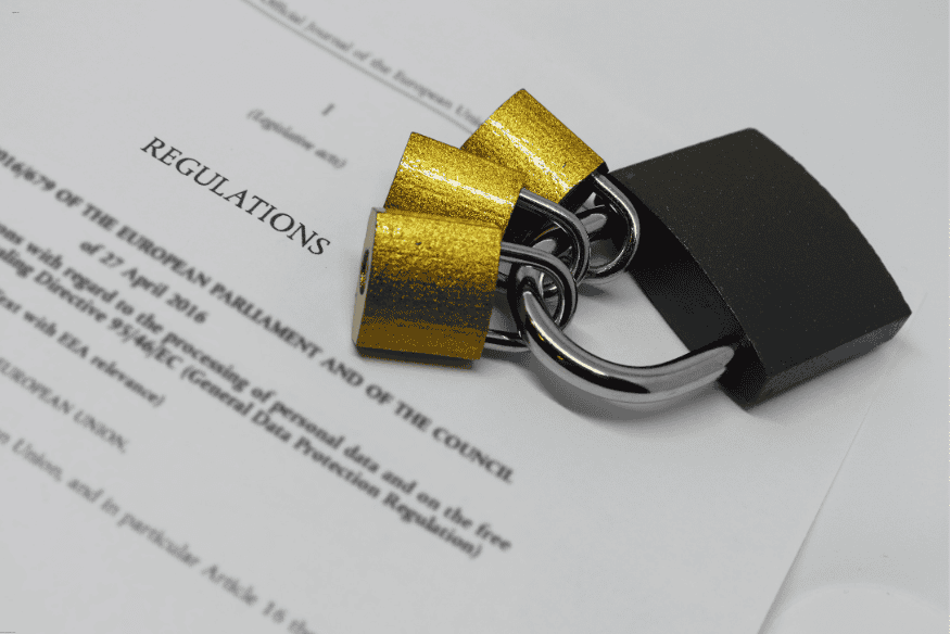 Três cadeados sobre documento com a palavra “Regulations”, simbolizando normas legais.